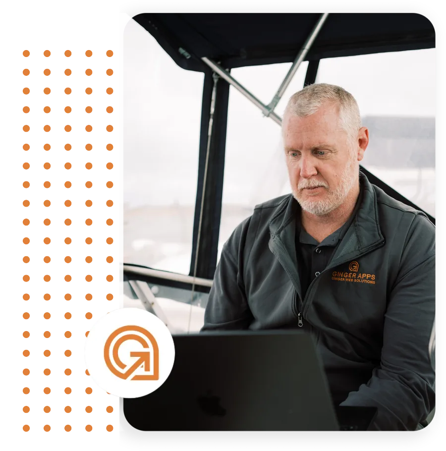 Paul Hashman of Ginger Web Solutions working on a laptop aboard a boat